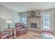 Comfortable living room boasts a brick fireplace, wood floors, and a cozy leather chair for relaxation at 886 Piccadilly Cir, Charleston, SC 29412