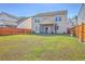 Expansive fenced-in backyard features green lawn and a screened-in porch for outdoor enjoyment at 9988 Winged Elm St, Ladson, SC 29456