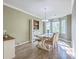 Elegant dining room with a farmhouse table, accent cabinet and natural light at 9988 Winged Elm St, Ladson, SC 29456