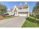 Attractive two-story home with a covered porch and a long concrete driveway and lawn at 9988 Winged Elm St, Ladson, SC 29456