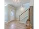 Bright foyer with hardwood floors, a staircase, and coat rack for a welcoming entry at 9988 Winged Elm St, Ladson, SC 29456