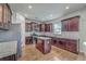 Spacious kitchen boasts granite countertops, stainless steel appliances, a large island, and wooden cabinets at 9988 Winged Elm St, Ladson, SC 29456