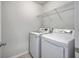 Bright laundry room featuring modern, white appliances and a wire shelf for storage at 9988 Winged Elm St, Ladson, SC 29456