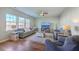Cozy living room with wood floors, ceiling fan, lots of natural light and comfortable seating at 9988 Winged Elm St, Ladson, SC 29456