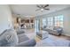 Open-concept living area showcasing wood floors, modern furnishings, and seamless flow to dining and kitchen at 9988 Winged Elm St, Ladson, SC 29456