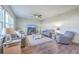 Bright living room featuring a ceiling fan, wood floors, and large windows for ample natural light at 9988 Winged Elm St, Ladson, SC 29456