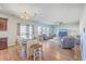 Inviting living space with eat-in kitchen, wood floors, modern ceiling fan, and natural light at 9988 Winged Elm St, Ladson, SC 29456