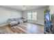 Bright living room with hardwood floors, a ceiling fan, and a comfortable gray couch at 9988 Winged Elm St, Ladson, SC 29456