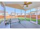 Relaxing screened porch with comfortable seating, offering a great view of the backyard at 9988 Winged Elm St, Ladson, SC 29456