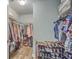 This walk-in closet is equipped with shelving and hanging rods for clothing and shoe storage at 9988 Winged Elm St, Ladson, SC 29456