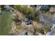 An aerial view of a home, showing the roof, yard, nearby lake and mature trees at 100 Lakeview Dr, Summerville, SC 29485