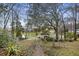 Scenic backyard with a brick path leading to a lakeside gazebo at 100 Lakeview Dr, Summerville, SC 29485