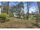 Picturesque backyard view showcasing the tranquil lake and charming gazebo at 100 Lakeview Dr, Summerville, SC 29485