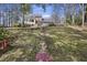 Brick steps lead to a home with a balcony overlooking a large yard, trees, and sky at 100 Lakeview Dr, Summerville, SC 29485