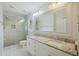 Bright bathroom featuring double sinks, granite countertops, and a glass door shower at 100 Lakeview Dr, Summerville, SC 29485