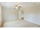 Inviting bedroom with a ceiling fan, window, and a door leading to the hallway at 100 Lakeview Dr, Summerville, SC 29485
