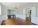 Open-concept dining room boasts hardwood floors, chandelier, and access to living room and kitchen at 100 Lakeview Dr, Summerville, SC 29485
