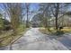 Long driveway leading to a charming home, surrounded by lush trees and landscaping at 100 Lakeview Dr, Summerville, SC 29485