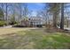 Landscaped lawn and mature trees surround this charming two-story home with a brick accent and a welcoming front porch at 100 Lakeview Dr, Summerville, SC 29485