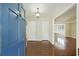 Inviting foyer featuring hardwood floors, a chandelier, and a glimpse into the adjacent living spaces at 100 Lakeview Dr, Summerville, SC 29485