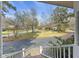 Inviting front porch offers a beautiful view of the front yard and mature trees, with brick accents at 100 Lakeview Dr, Summerville, SC 29485