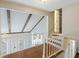 Hallway featuring hardwood floors, wood beams, and an overlook into the living room at 100 Lakeview Dr, Summerville, SC 29485