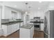 Fully equipped kitchen with white cabinets, an island, stainless steel appliances, and granite countertops at 100 Lakeview Dr, Summerville, SC 29485