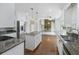 Bright kitchen has an island, granite countertops, stainless appliances, and open view to a living area at 100 Lakeview Dr, Summerville, SC 29485