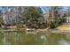 A scenic view of a lake with a private dock and waterfront home at 100 Lakeview Dr, Summerville, SC 29485