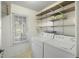 Bright laundry room with washer, dryer, shelving, and a window to the outdoors at 100 Lakeview Dr, Summerville, SC 29485