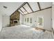 Spacious living room with stone fireplace, beamed ceiling, and ample natural light at 100 Lakeview Dr, Summerville, SC 29485