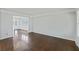 Spacious living room showcasing hardwood floors and elegant trim, leading into the dining room at 100 Lakeview Dr, Summerville, SC 29485