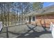 Spacious rooftop deck with white railing overlooking trees and a brick home exterior at 100 Lakeview Dr, Summerville, SC 29485