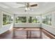 Cozy sunroom with multiple windows provides natural light and scenic views of the lush backyard at 100 Lakeview Dr, Summerville, SC 29485