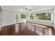 Bright sunroom featuring hardwood floors, ceiling fan, and large windows offering an outdoor view at 100 Lakeview Dr, Summerville, SC 29485