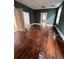 Spacious bedroom featuring original hardwood floors, deep green walls and lots of natural light at 101 Queen St, Charleston, SC 29401