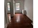 Bedroom features a bright window, wooden floors, and closet with shelving, offering cozy living at 101 Queen St, Charleston, SC 29401