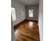This is a bedroom featuring freshly finished wooden floors and two windows at 101 Queen St, Charleston, SC 29401