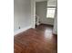 Empty room with wood floors, a staircase and a window with blinds at 101 Queen St, Charleston, SC 29401