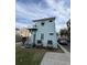 Rear view of a light blue two-story home with stairs leading to a second story door at 101 Queen St, Charleston, SC 29401