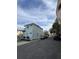 Exterior view of light blue two-story house including an outside staircase on the back at 101 Queen St, Charleston, SC 29401