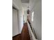 Hallway featuring wood floors, white walls and chandelier at 101 Queen St, Charleston, SC 29401