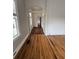 Hallway with an archway, newly finished hardwood floors, and natural light from the windows at 101 Queen St, Charleston, SC 29401