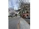 A quiet neighborhood street lined with trees and houses showcasing neighborhood living at 101 Queen St, Charleston, SC 29401