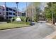 View of the gated entrance to The Retreat Luxury Condominiums featuring landscaped signage and controlled access at 1025 Riverland Woods Pl # 116, Charleston, SC 29412