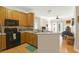 Bright kitchen with counter seating, and seamless view into the living room with a fireplace at 1025 Riverland Woods Pl # 116, Charleston, SC 29412