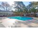 Community pool surrounded by lush landscaping and comfortable lounging areas at 1025 Riverland Woods Pl # 116, Charleston, SC 29412