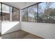 Screened porch offering views of mature trees and nearby buildings at 1025 Riverland Woods Pl # 116, Charleston, SC 29412