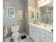 Clean and bright bathroom with a single vanity and decorative mirrors at 1025 Riverland Woods Pl # 907, Charleston, SC 29412