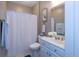 Well-lit bathroom with a shower and vanity with white cabinetry at 1025 Riverland Woods Pl # 907, Charleston, SC 29412